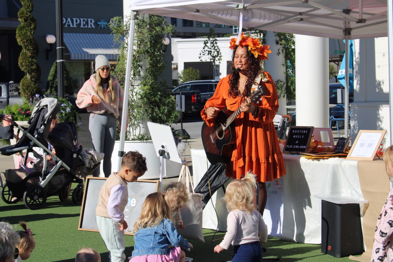 Live guitar and playful musical moments with families.